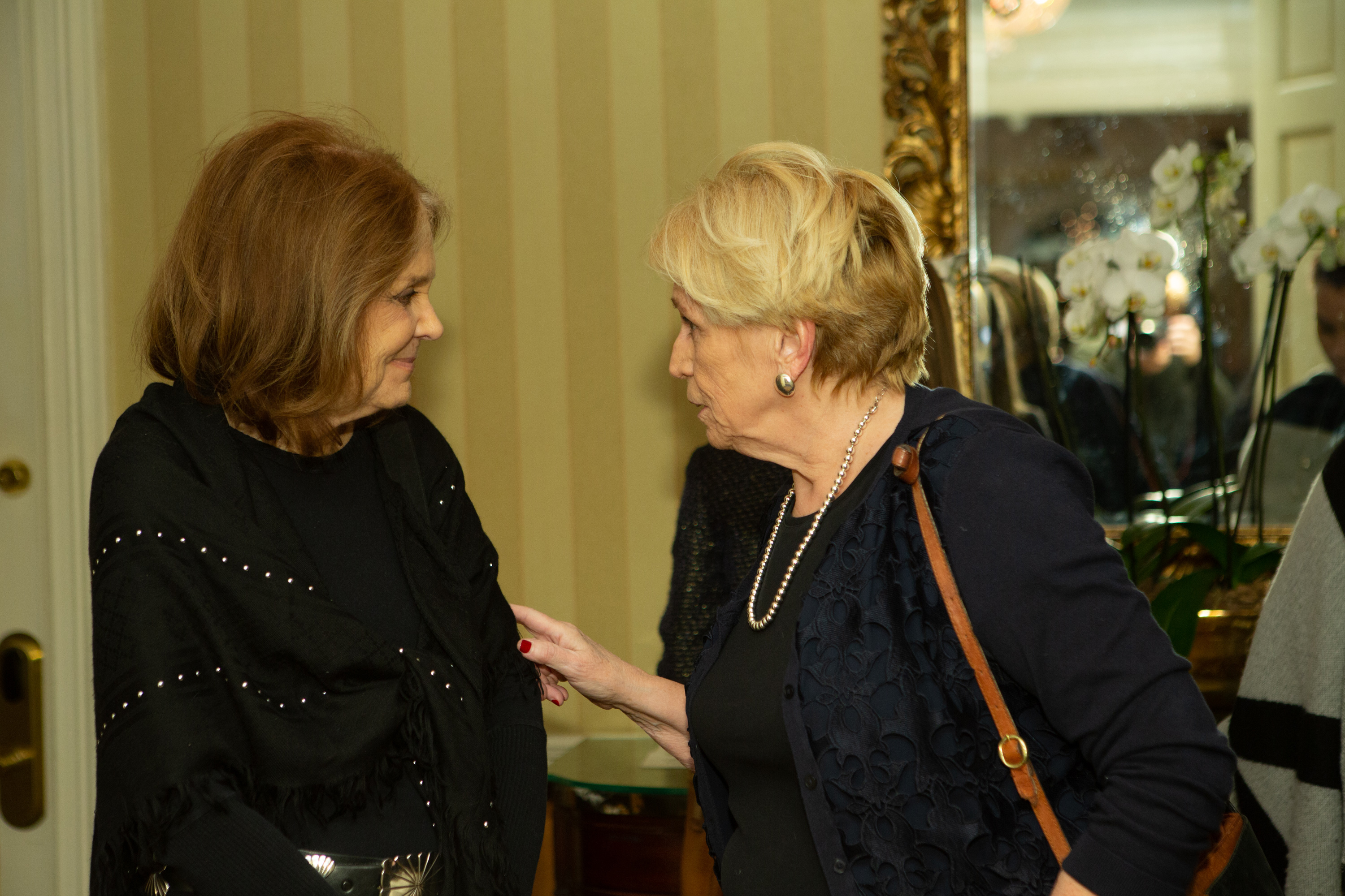 Gloria Steinem listens as Margaret McKenna talks to her