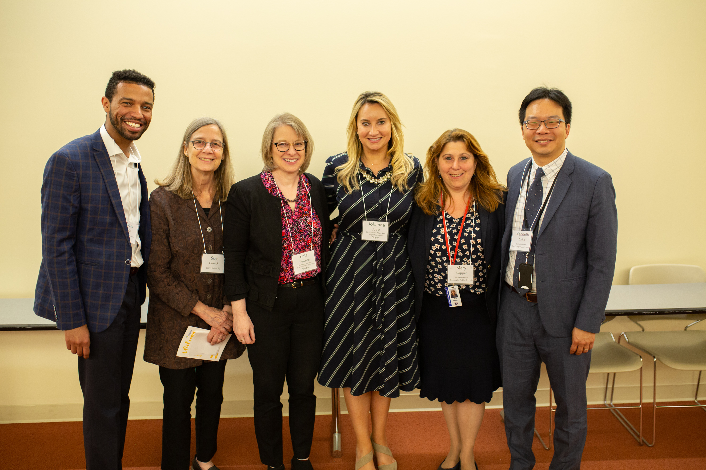 A group of officials pose for a photo at the Biogen showcase.