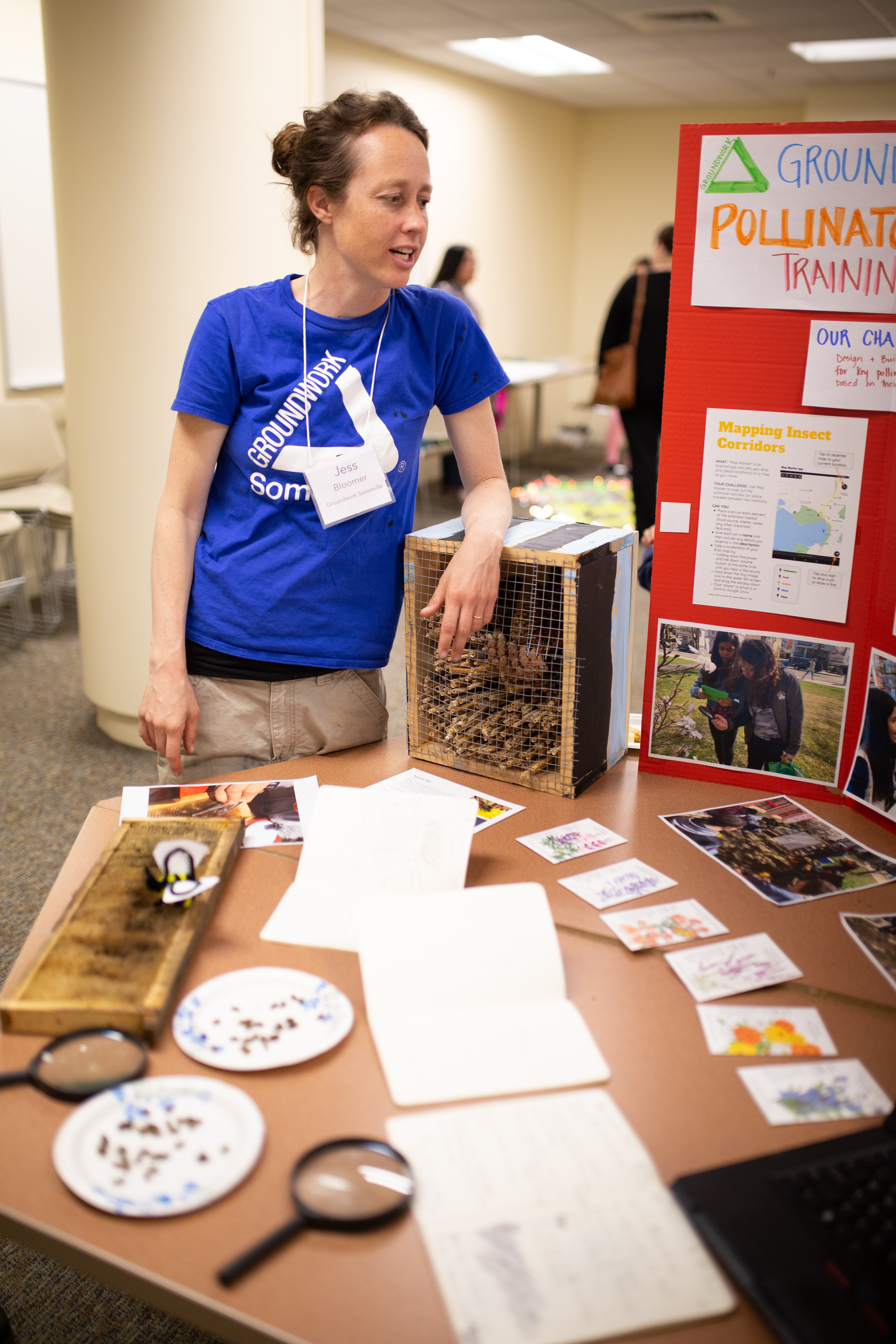 Jess Bloomer stands next to a table while speaking