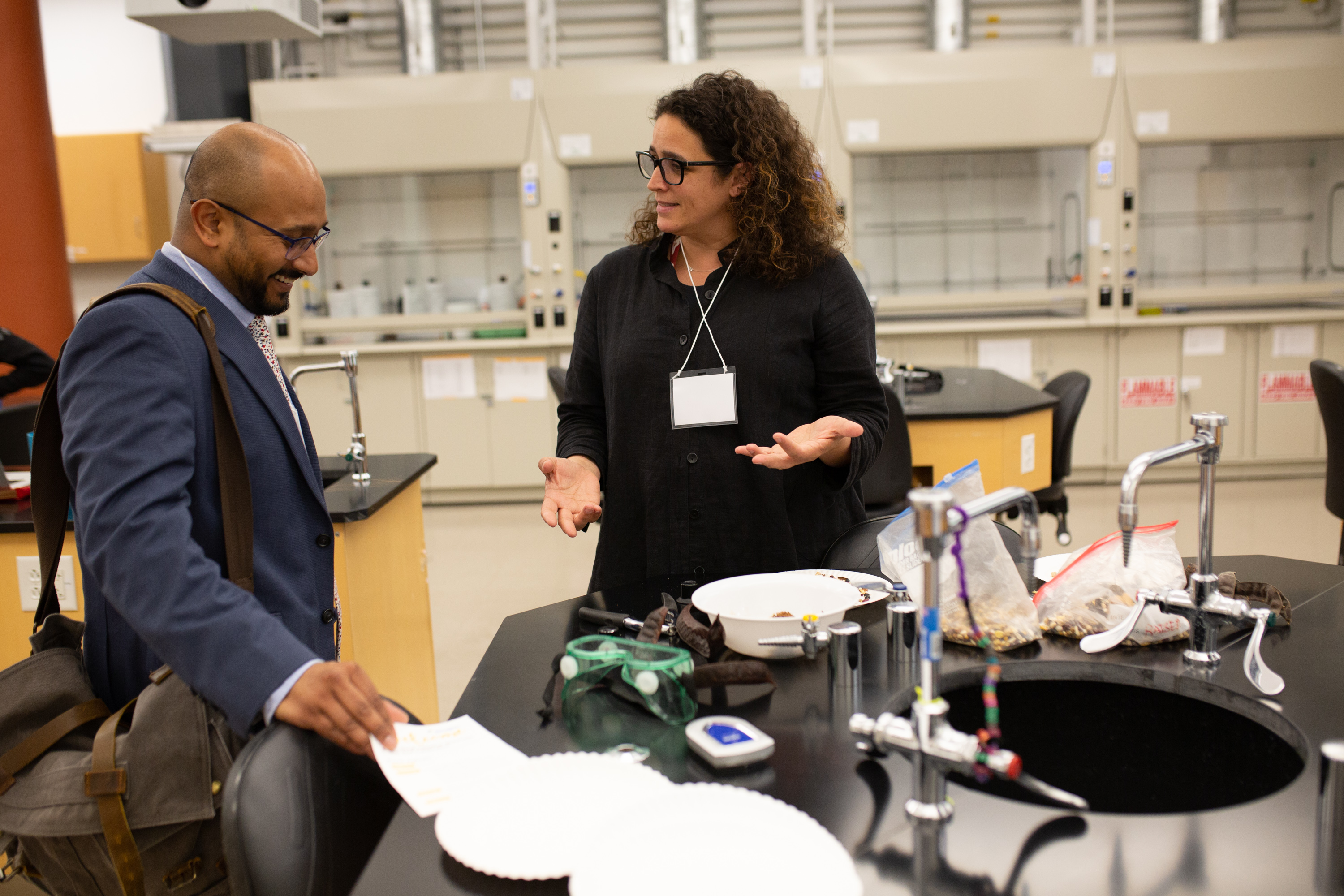 Nicole Weber speaks to someone in a science lab