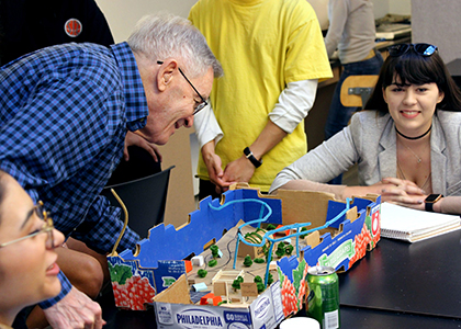 Steve Salmon reviews one team's "Elder Park," with Christine Lopez Corado (left) and Stacia Pedersen (right).