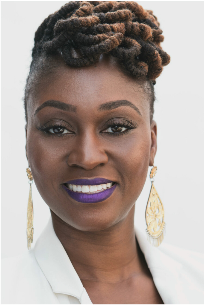 Headshot of Ebony Nichols smiling at the camera, wearing a white blazer