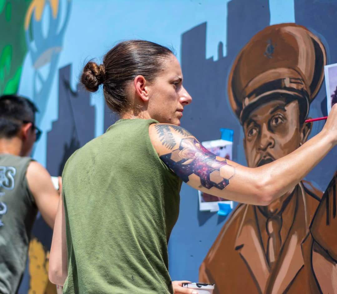 Sgt. Elize McKeley painting a mural