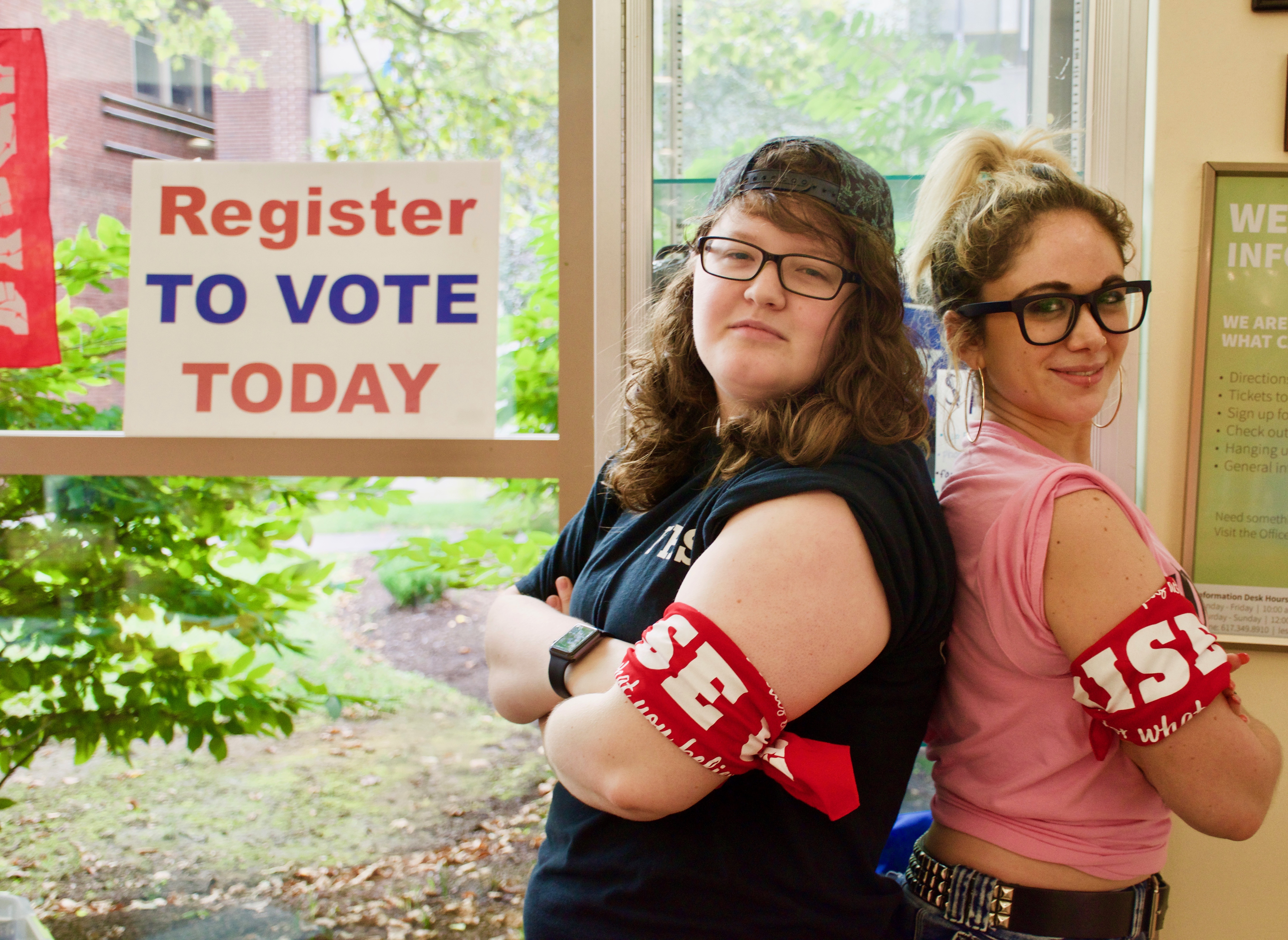 Students stand back to back in the student center at a voter registration event.