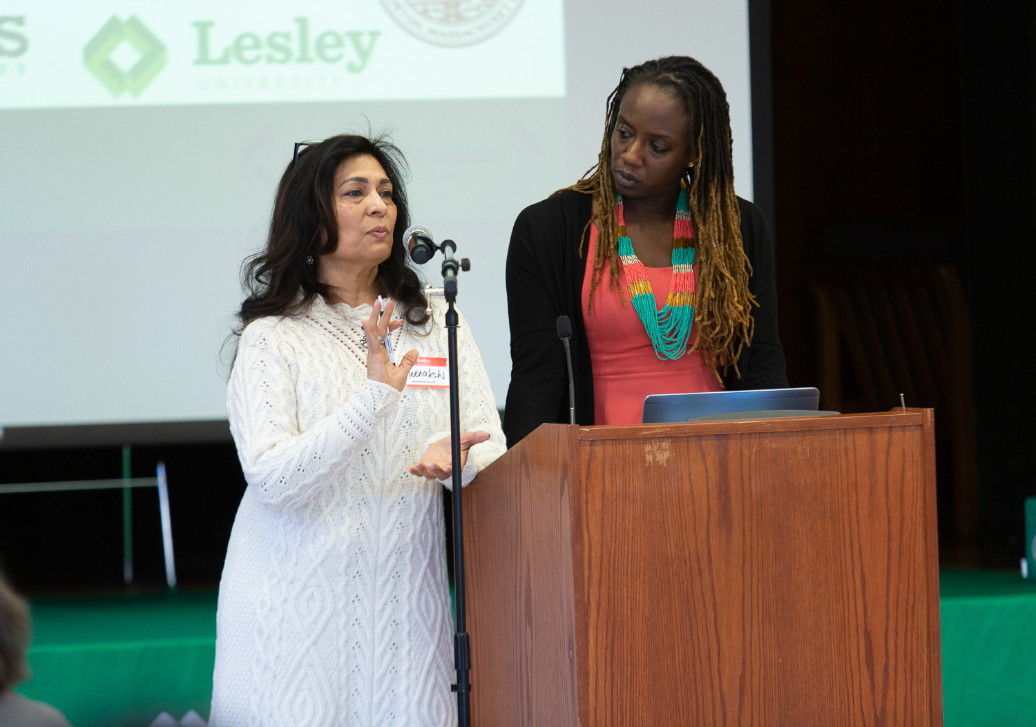 Meenakshi Chhabra and Nina Harris speak at the podium