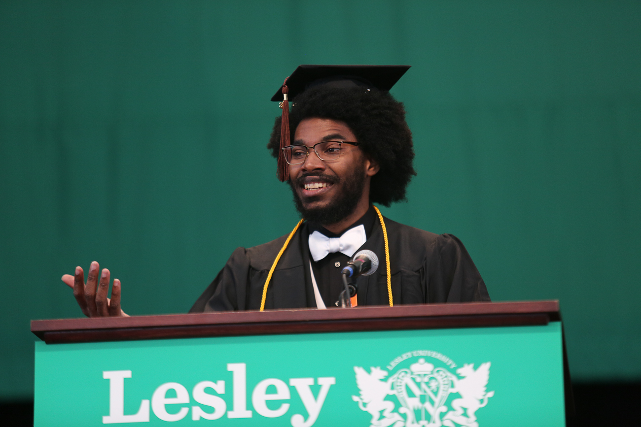 Michael Talbot in his graduation gear at the podium