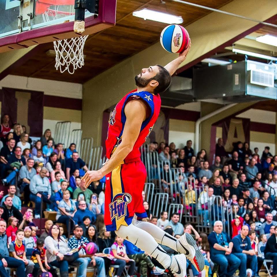 Mike Kaufman jumps for a dunk on the court.