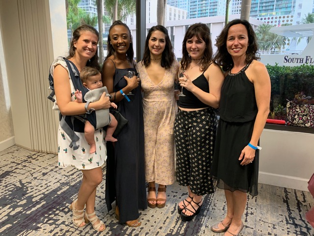 Group of 5 women dressed up and posing for a photo at an awards ceremony