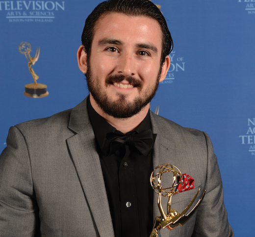 Devin Ferreira holding his Emmy.