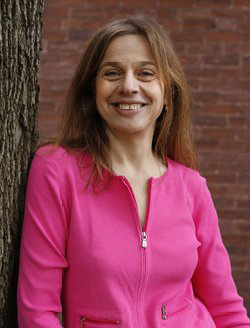 Susan Goodman portrait leaning against a tree.