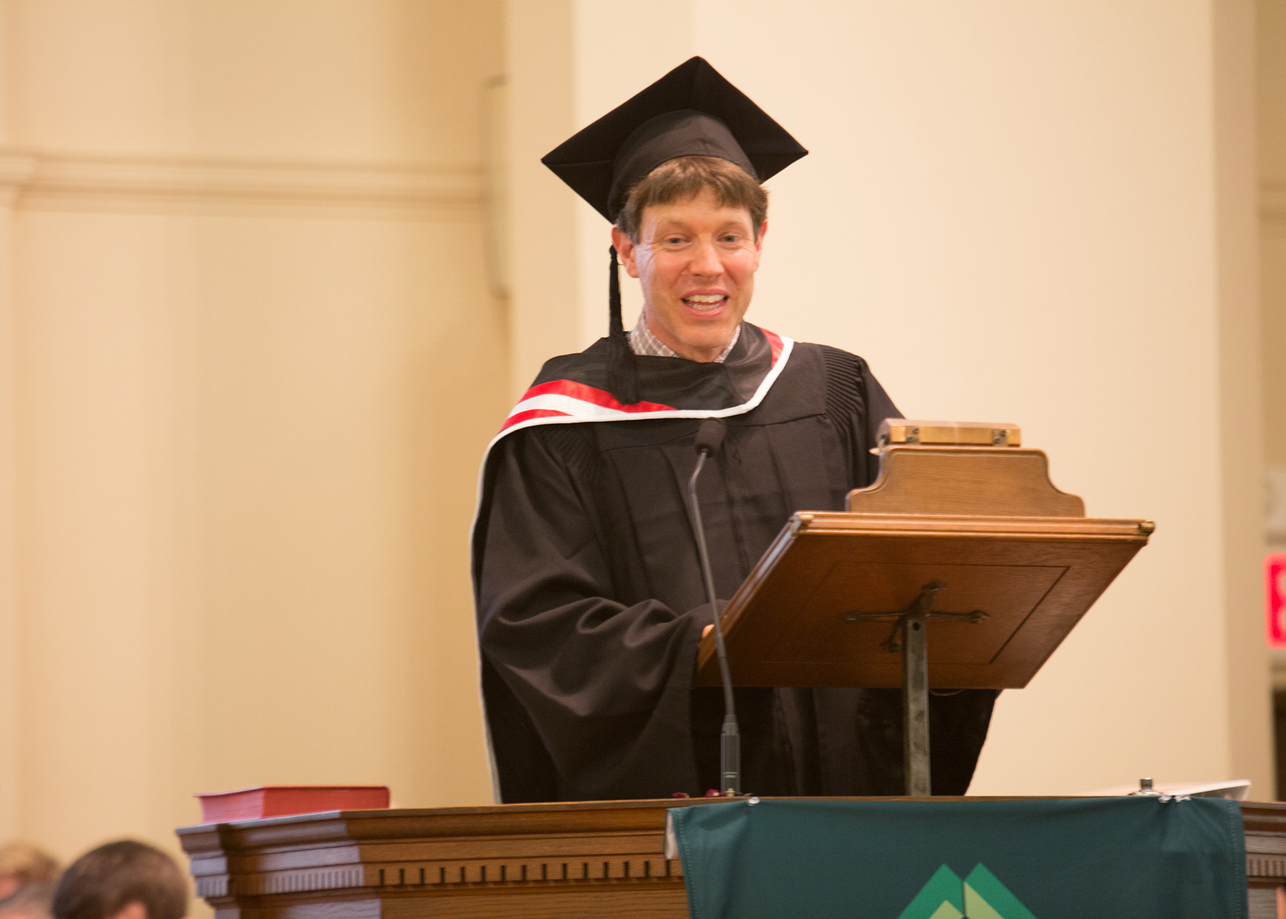 Devin Meyer stands at the podium delivering a speech.