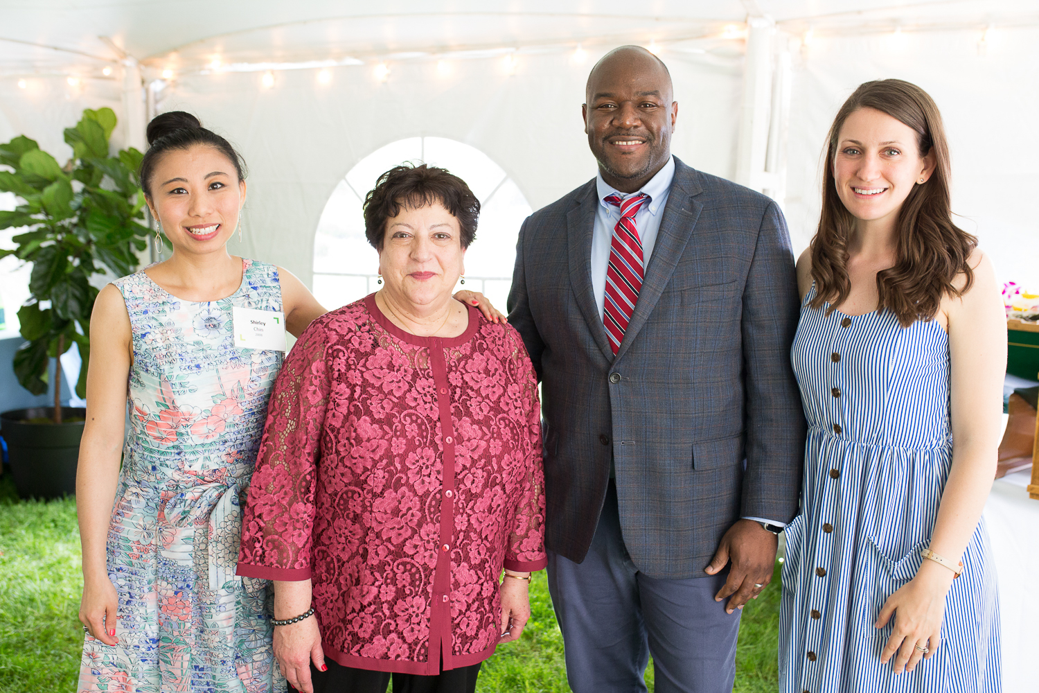 The four alumni award winners pose under the tent