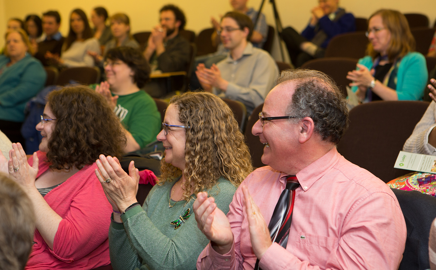 June Fox Lecture audience members smiling and clapping