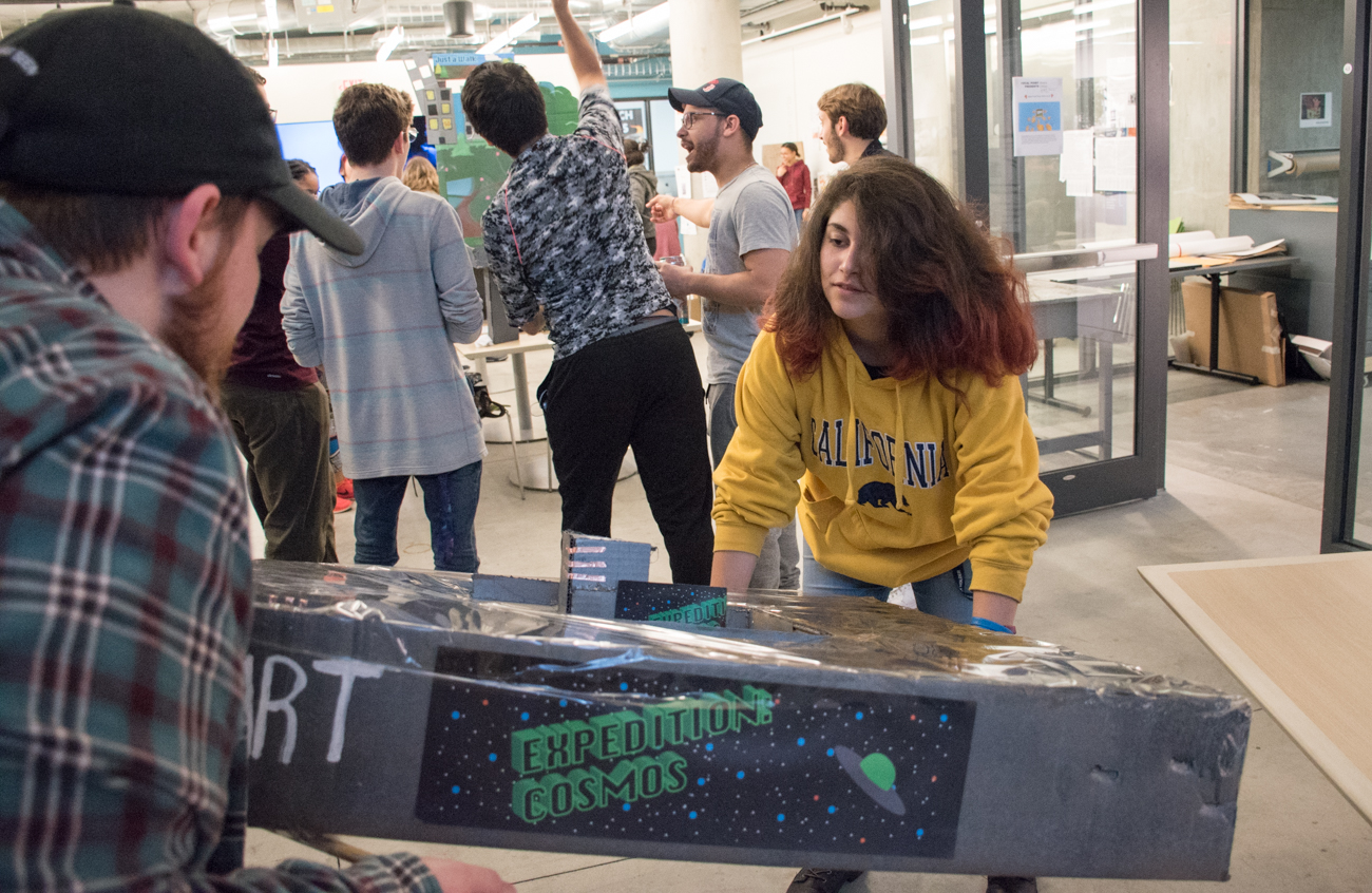 Two students play an interactive maze game.