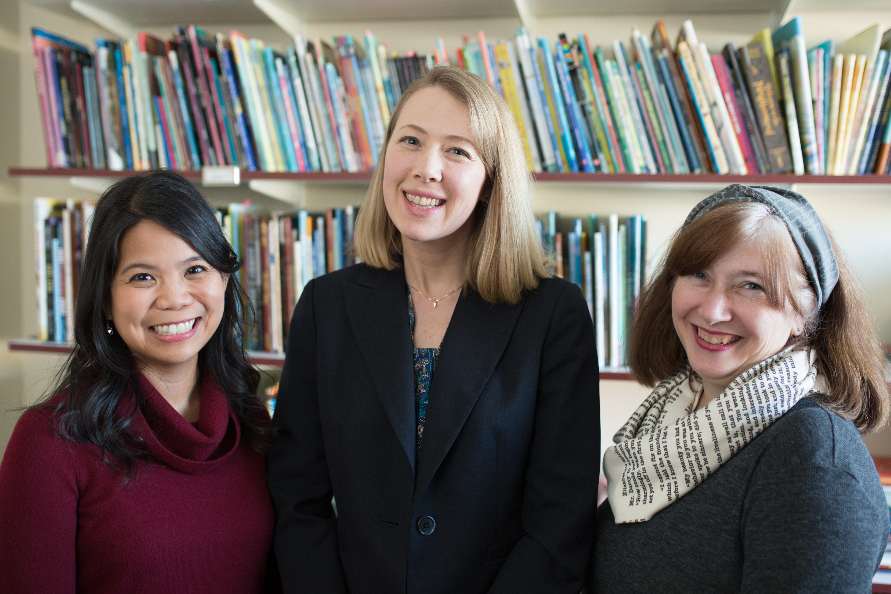 Classroom Bookshelf authors Grace Enriquez, Erika Thulin Dawes, and Mary Ann Cappiello, in front of bookshelf