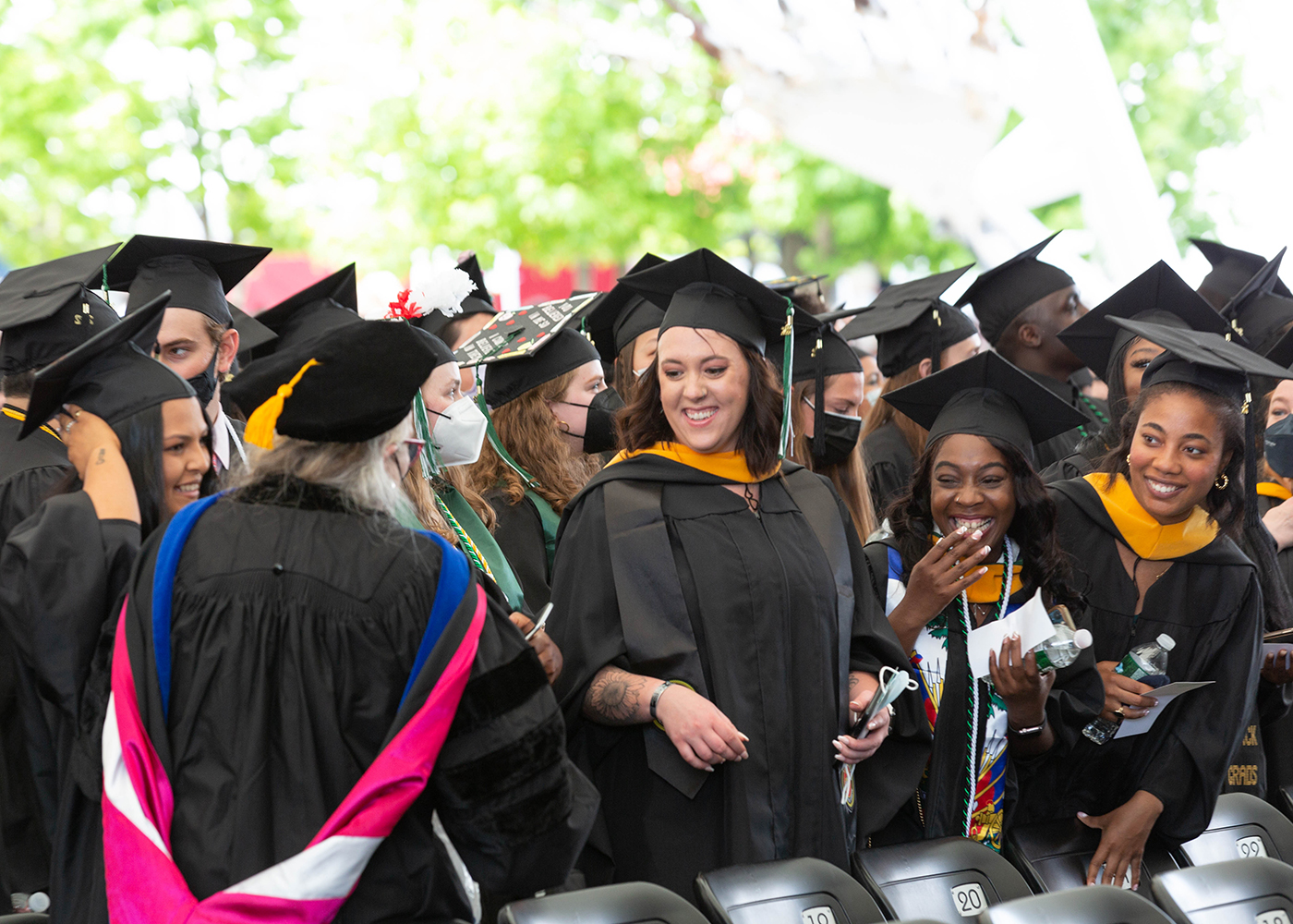 Graduates smile during Commencement