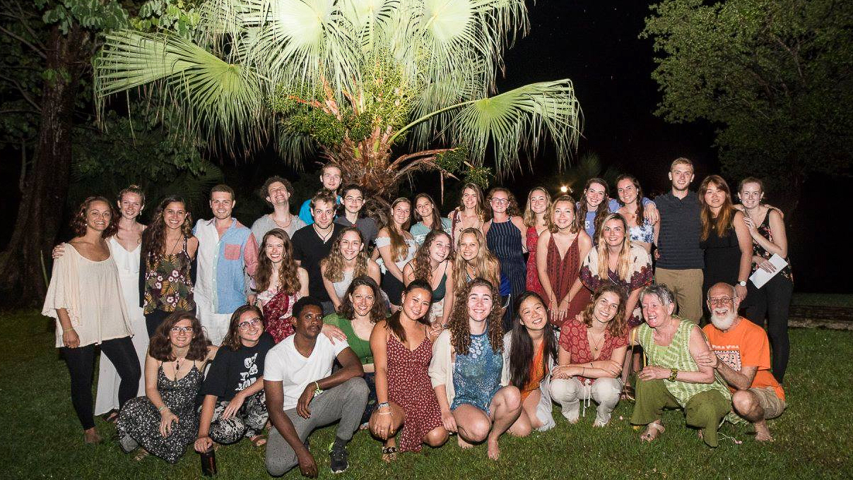 Group shot at night of the students and faculty.