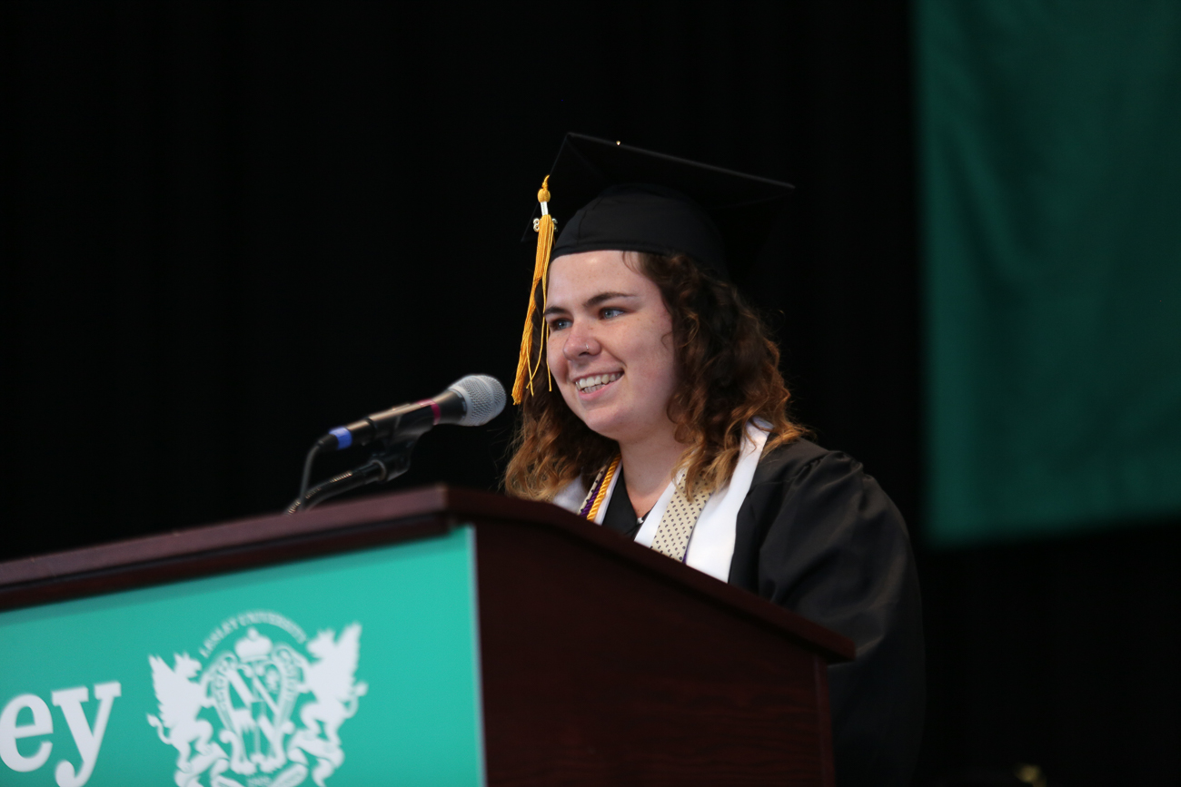 Student Hanna Henshaw speaks from the podium