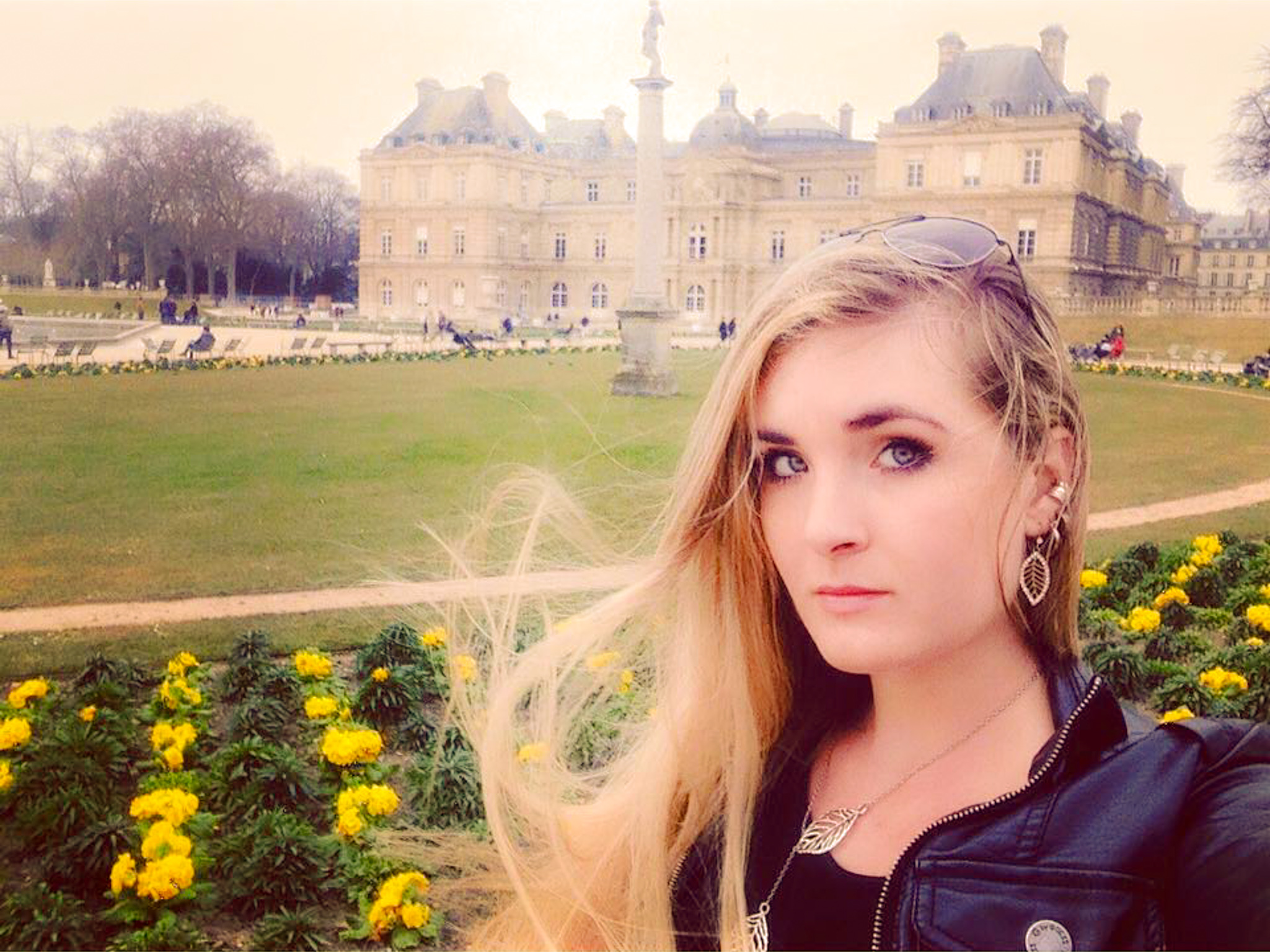 Student Kristina Mccue standing in front of mansion