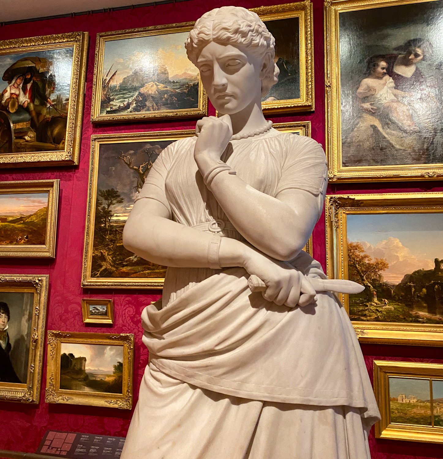 A close up of a statue of a woman in a museum