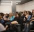 students listen to a presentation in screening room