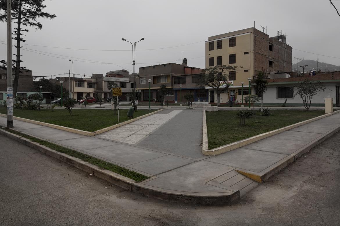 photograph of old buildings with gray skies and parking lot in background