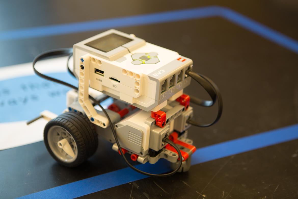 Student built motorized lego with wheels sitting on a table