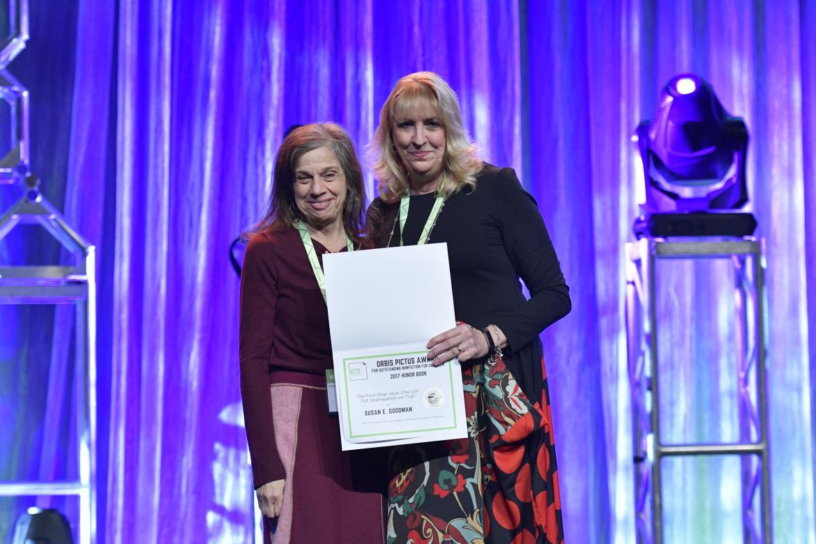 Susan Goodman holds the award for her book "The First Step."