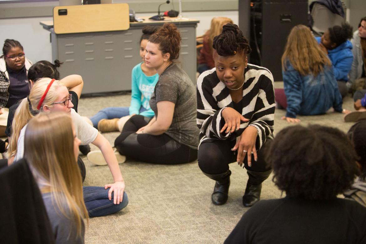 Group of students sitting on the floor talking