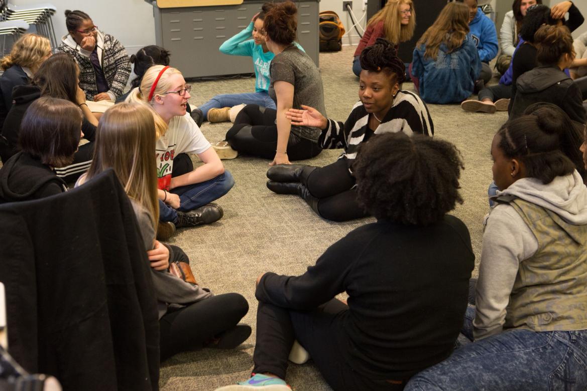 Girls sitting on the floor.