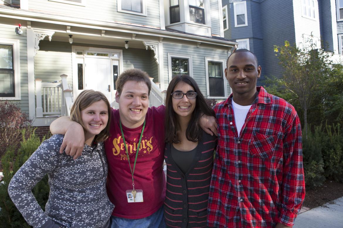 threshold student house with students in front 