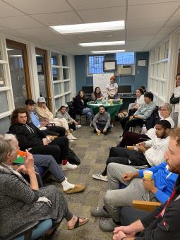 Group of students, faculty and staff sitting in a room for a meeting about internship opportunities