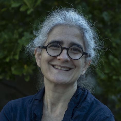 photo of ayse smiling in front of a tree